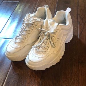 All white Fila Disruptors